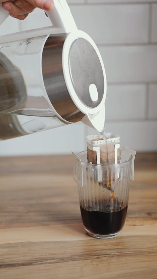 A Person Pouring Hot Water on Drip Coffee