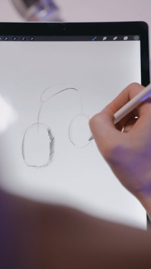 A Person Drawing on a Digital Tablet