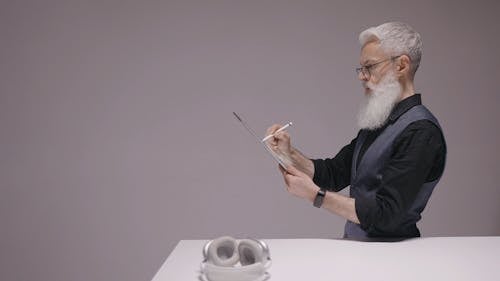 Man With Facial Hair Using a Tablet