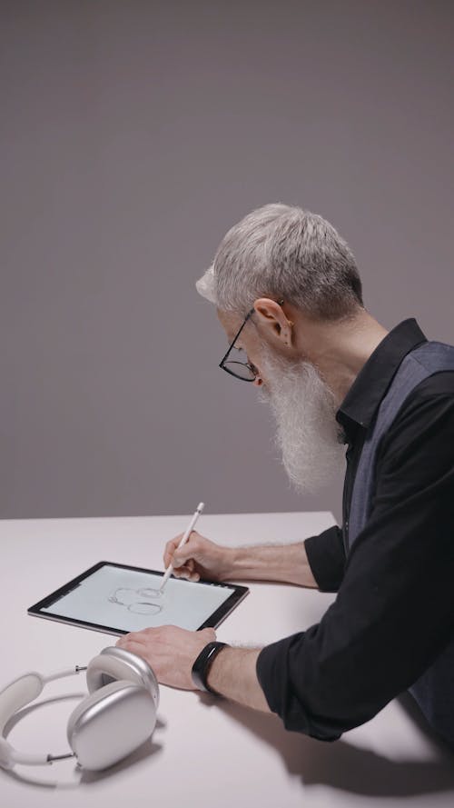 A Man Working with a Digital Tablet 