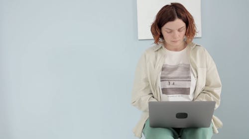 A Stressed Woman Using a Laptop