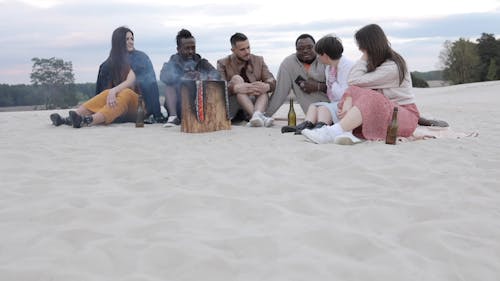 People Talking while Sitting on the Ground