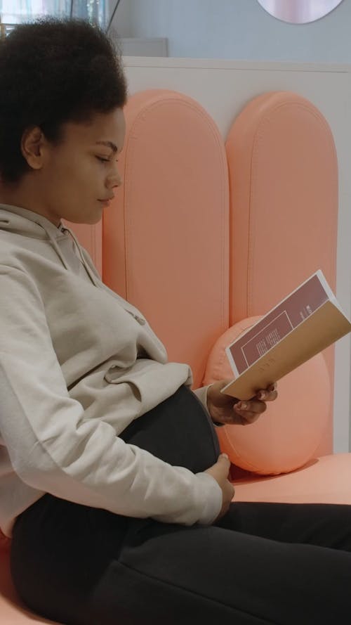 Pregnant Woman is Reading a Brochure