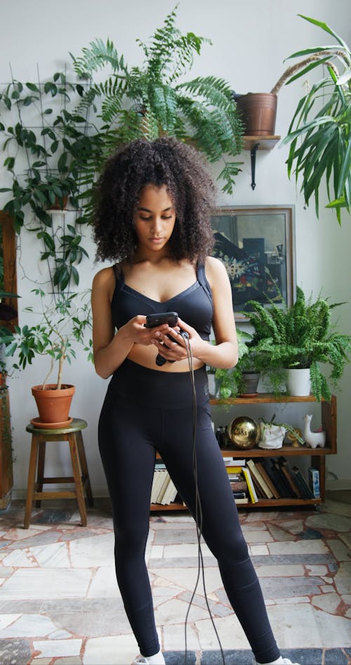 Beautiful Woman Wearing Sportswear Using a Cellphone