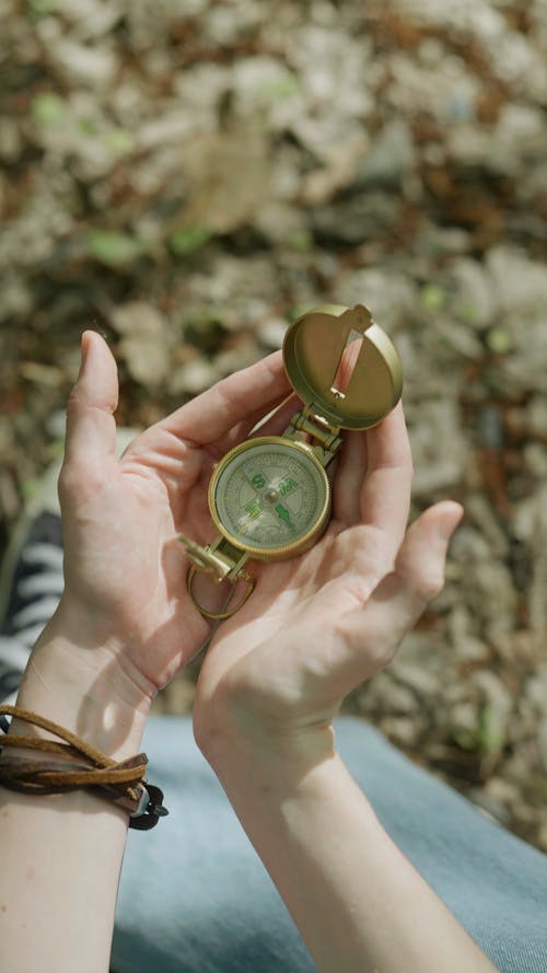 A Person Holding A Compass