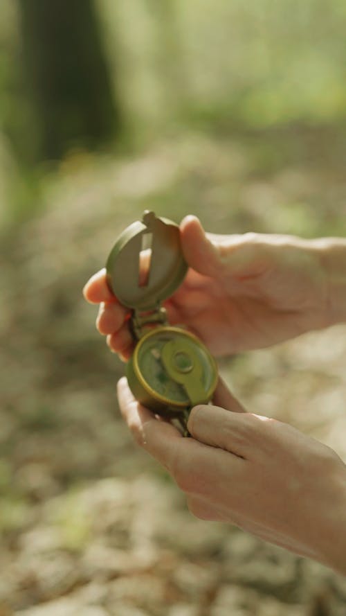 A Person Holding A Compass