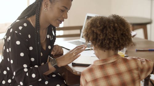 A Woman Using a Tablet with a Little Boy