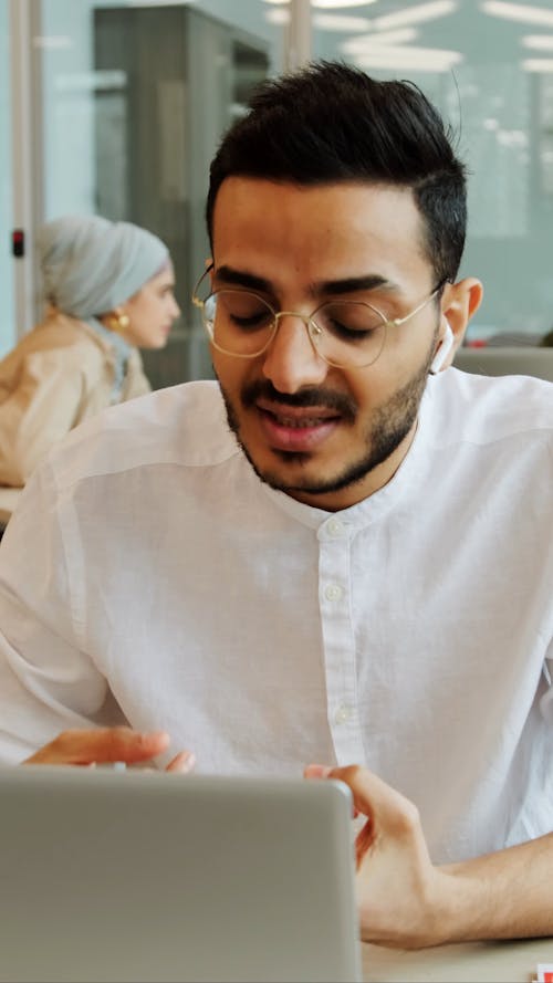 Man is Using Laptop while Having Video Call