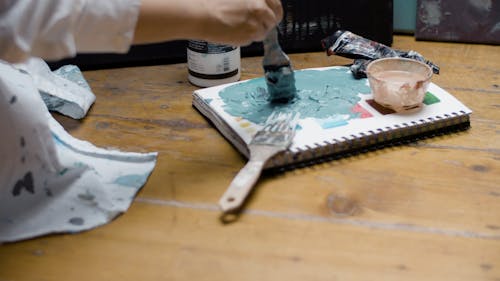 Woman using Blue Paint while Painting