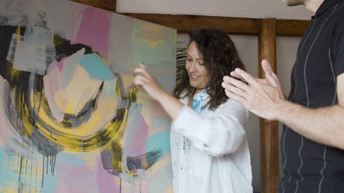 Woman Showing the Painting to a Man