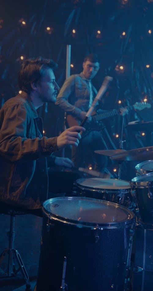 Men Playing the Guitar and the Drums