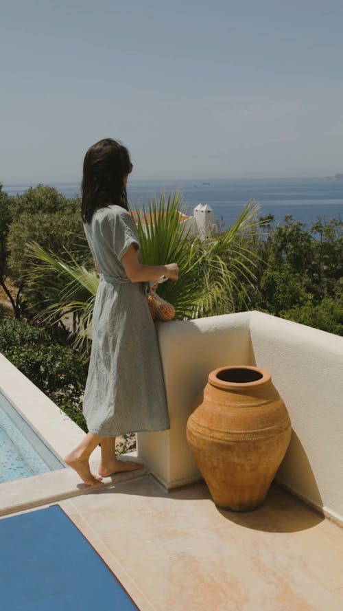 A Woman Standing by the Poolside