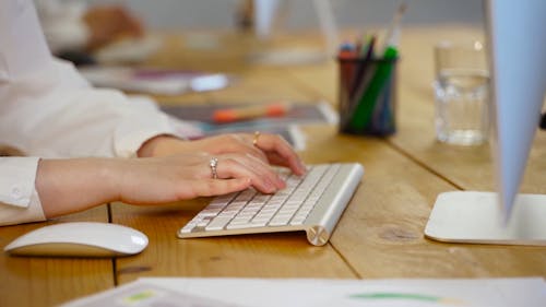 A Person Typing on a Keyboard