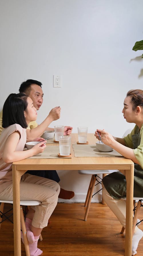A Family Having a Conversation over a Meal