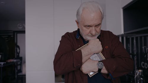 Elderly Man Embracing a Picture Frame