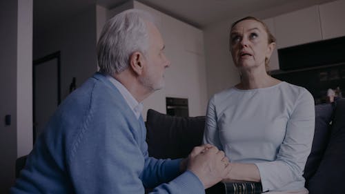 Elderly Man Comforting His Wife