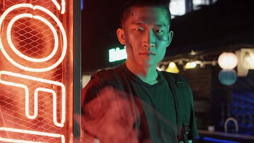 A Man Looking at Camera While Leaning on the Wall in the Bar