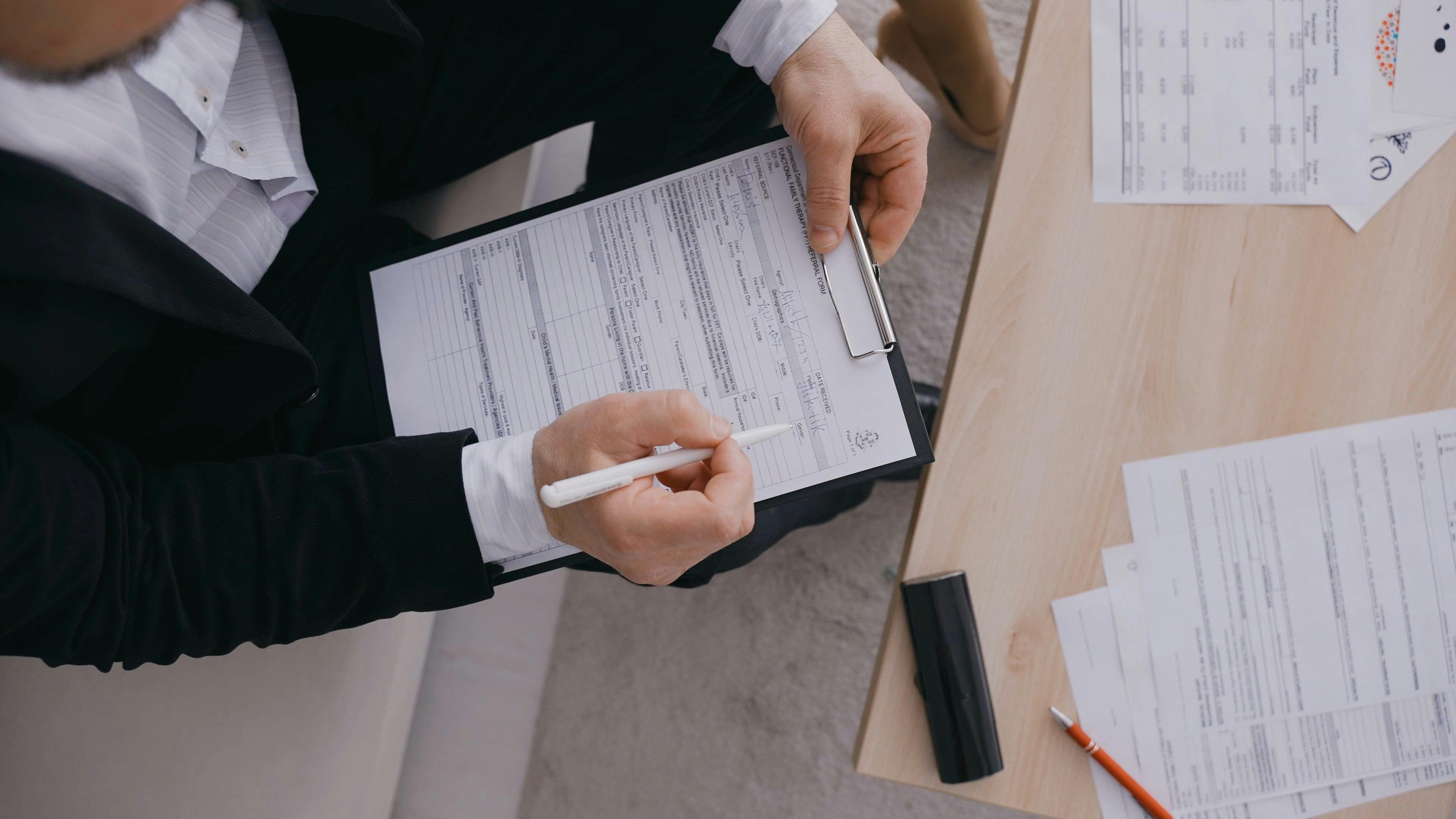 A person filling up a form free stock video
