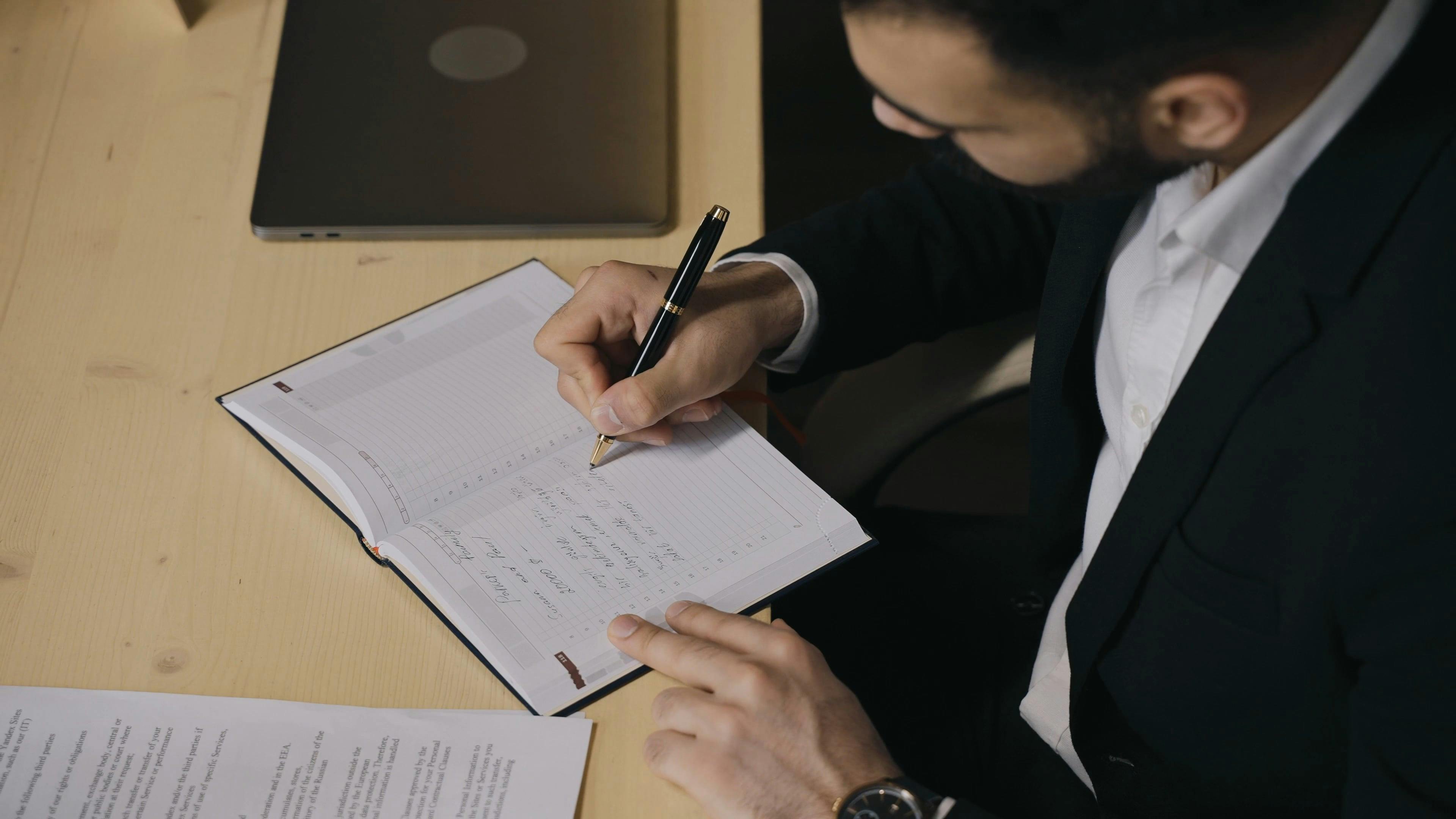 Person Writing in Notebook · Free Stock Video