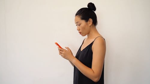 Woman using Smartphone while Video Recording