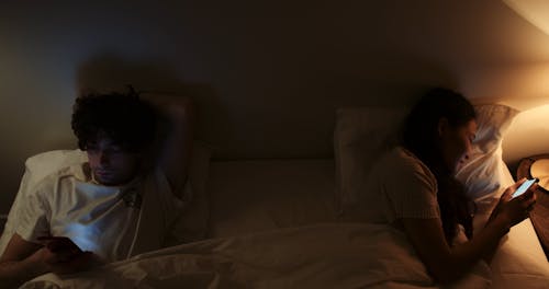 People Using Cellphone While Lying on Bed