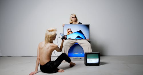 Video of Woman sitting on a CRT Television
