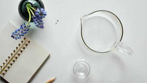 A Person Pouring Water on a Pitcher