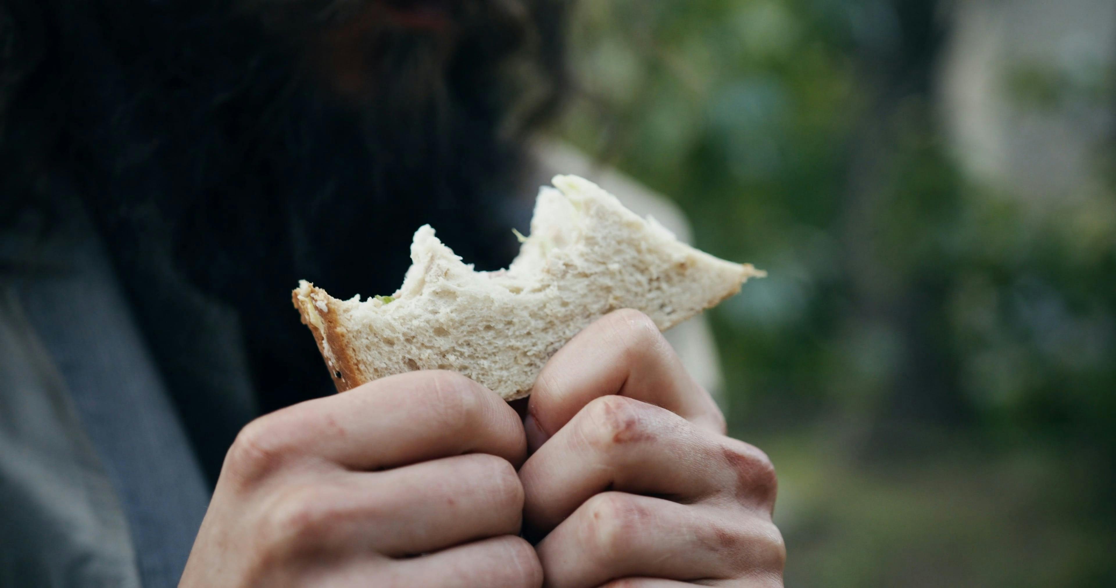 A Homeless Person Eating Bread · Free Stock Video