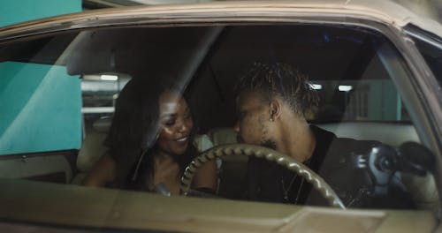 Happy Couple Kissing in the Car