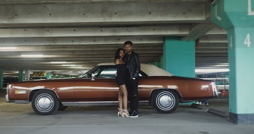 Couple Standing by the Vintage Car