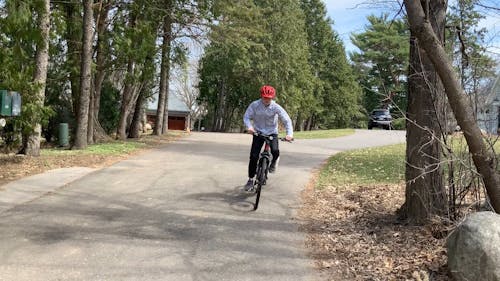 Person Wearing Helmet Riding a Bicycle