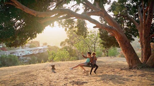 Boy and Girl Swinging Together