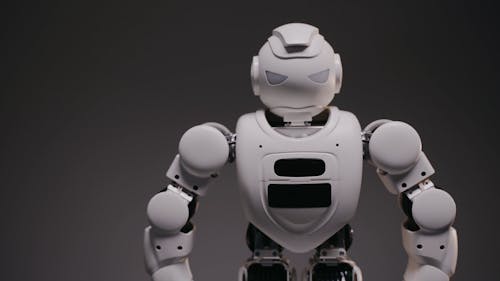 A Footage of a White Robot on a Black Surface
