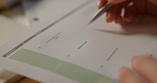 A Person Writing Day Off on a Calendar · Free Stock Video