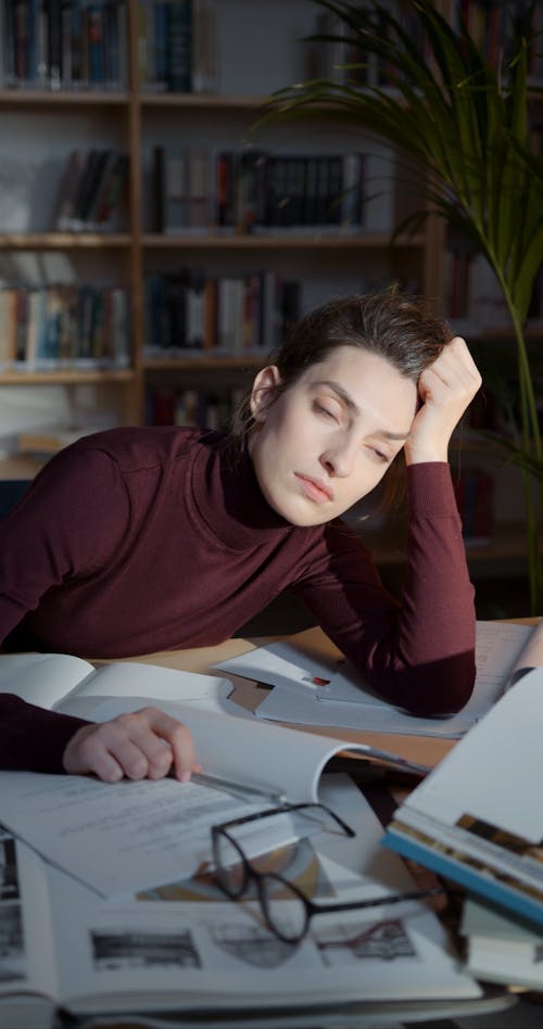 Woman Looking Tired While Self-studying