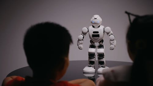 Boy and Girl Watching a Robot