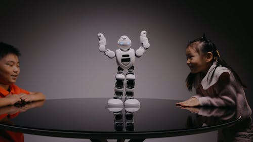 Girl and Boy Watching a Robot Dance