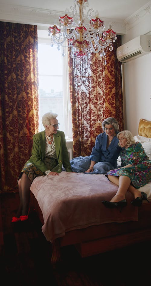 Elderly Women Talking on a Bed