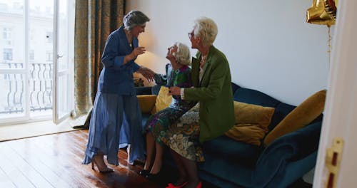 Elderly Women Laughing on a Couch