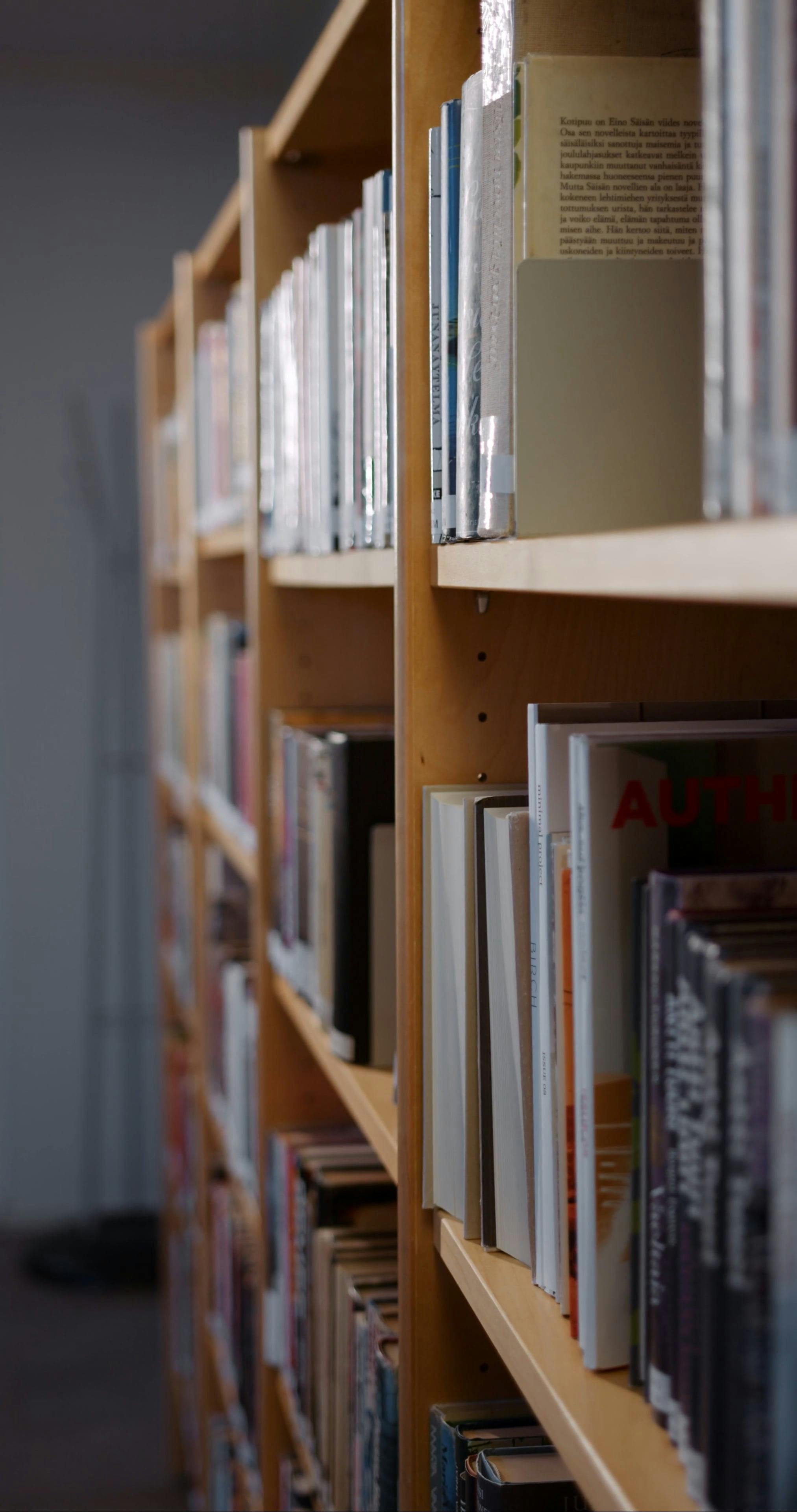 A Woman Getting a Book from a Book Shelf · Free Stock Video