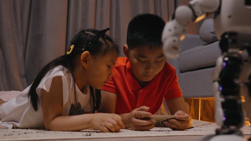 Children Playing with a Toy Robot