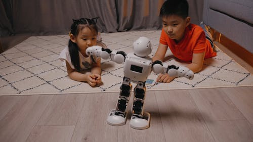 Children Playing with a Toy Robot