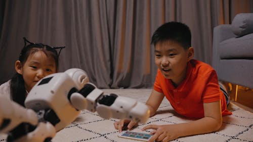 Boy and Girl Watching a Robot