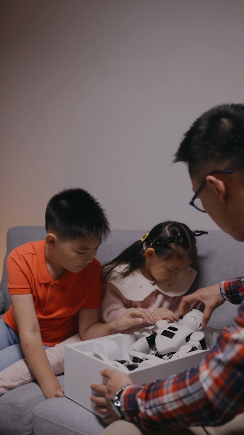 Dad Showing his Children the Robot