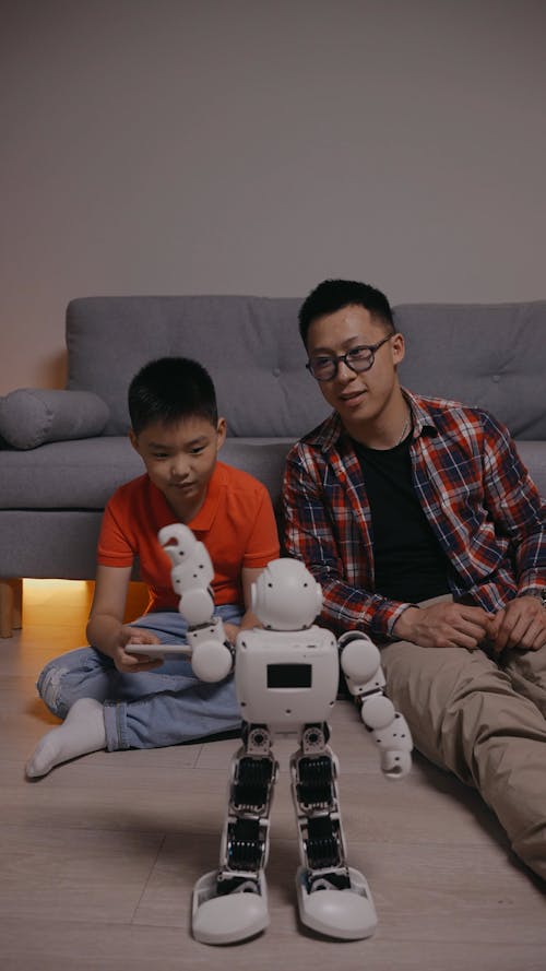 A Child Playing with a Toy Robot