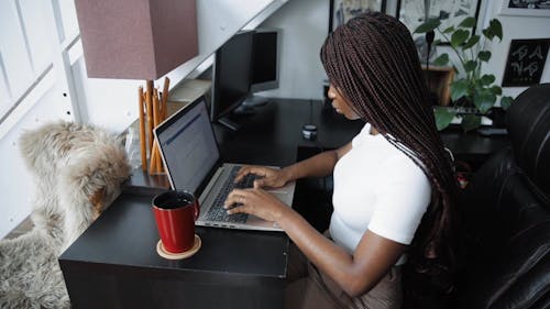Side View of a Woman Using a Laptop