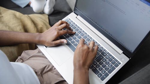 A Person Typing using a Laptop