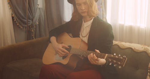 A Young Man Playing the Guitar