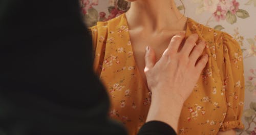 A Person Touching a Woman's Chest