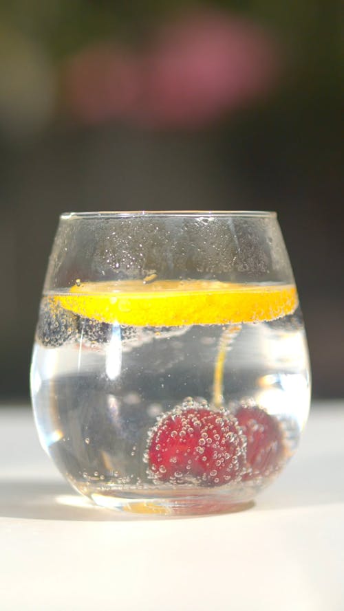 Berries and a Slice of Lemon Soaked in a Cocktail